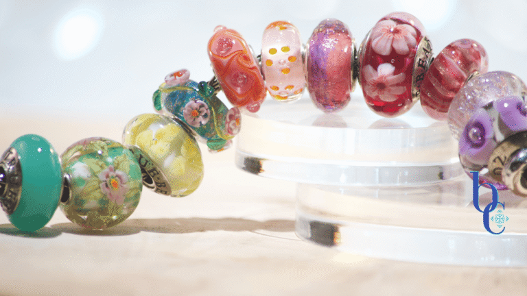 Image of an fun ombre European bracelet design by BijouxChat.com that features an assortment of Elfbeads and TrueBeadz beautifully colored beads arranged on a light grey backdrop.