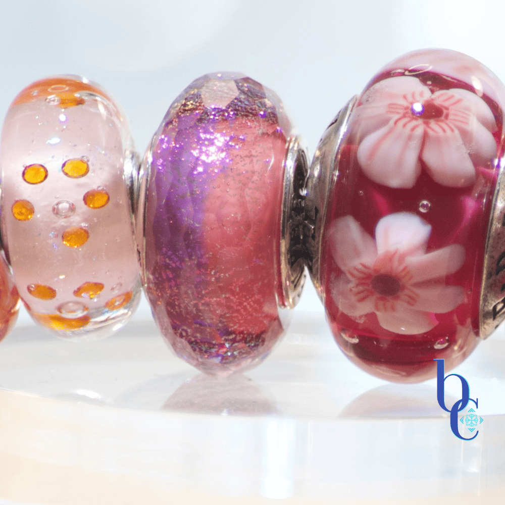 Image of an fun ombre European bracelet design by BijouxChat.com that features an assortment of Elfbeads and TrueBeadz beautifully colored beads  arranged on a light grey backdrop.