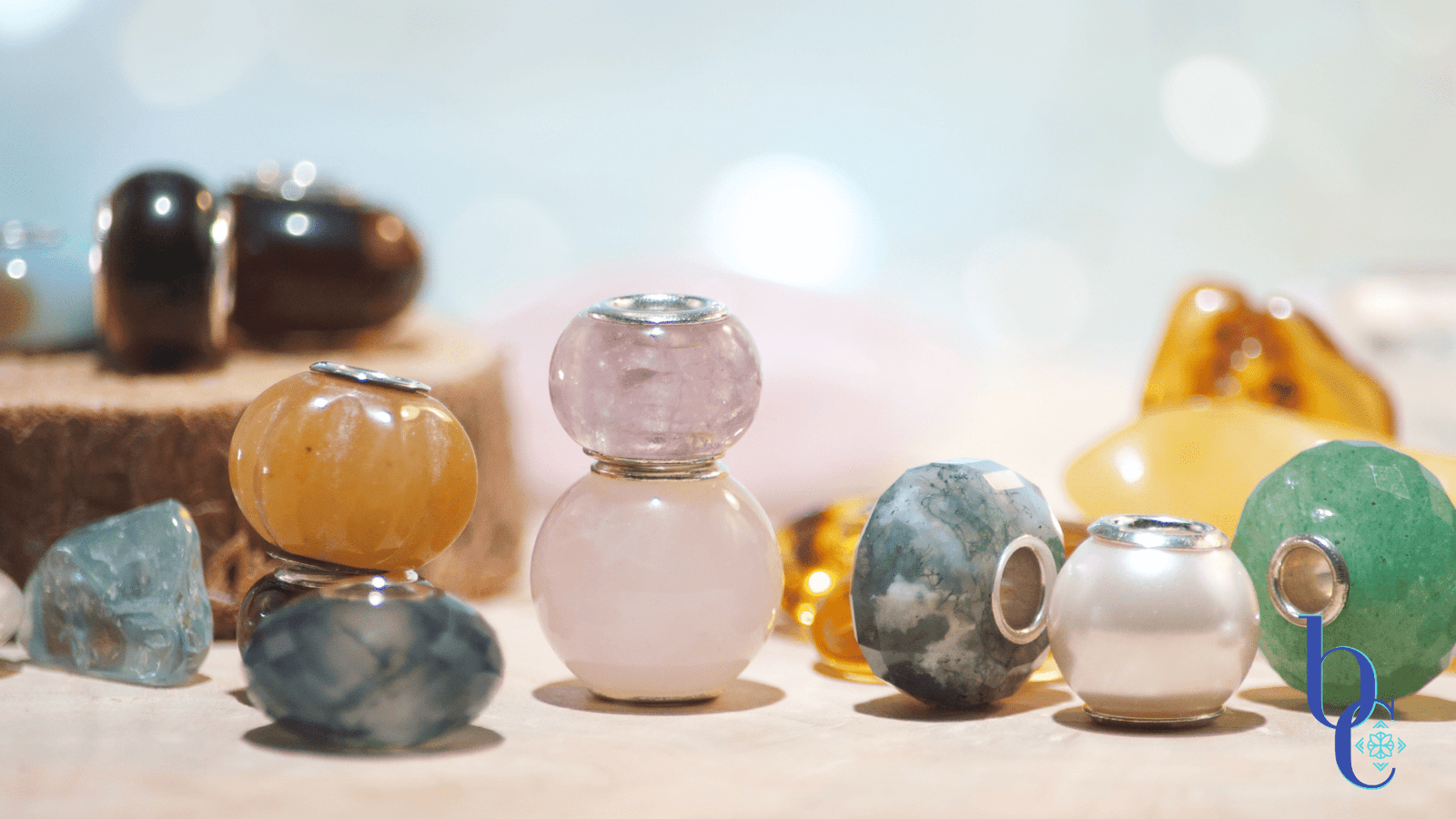 An Image of natural stone European bracelet beads with sterling silver cores. The lighting makes them sparkle and shine and shows their translucence and delicate nature.