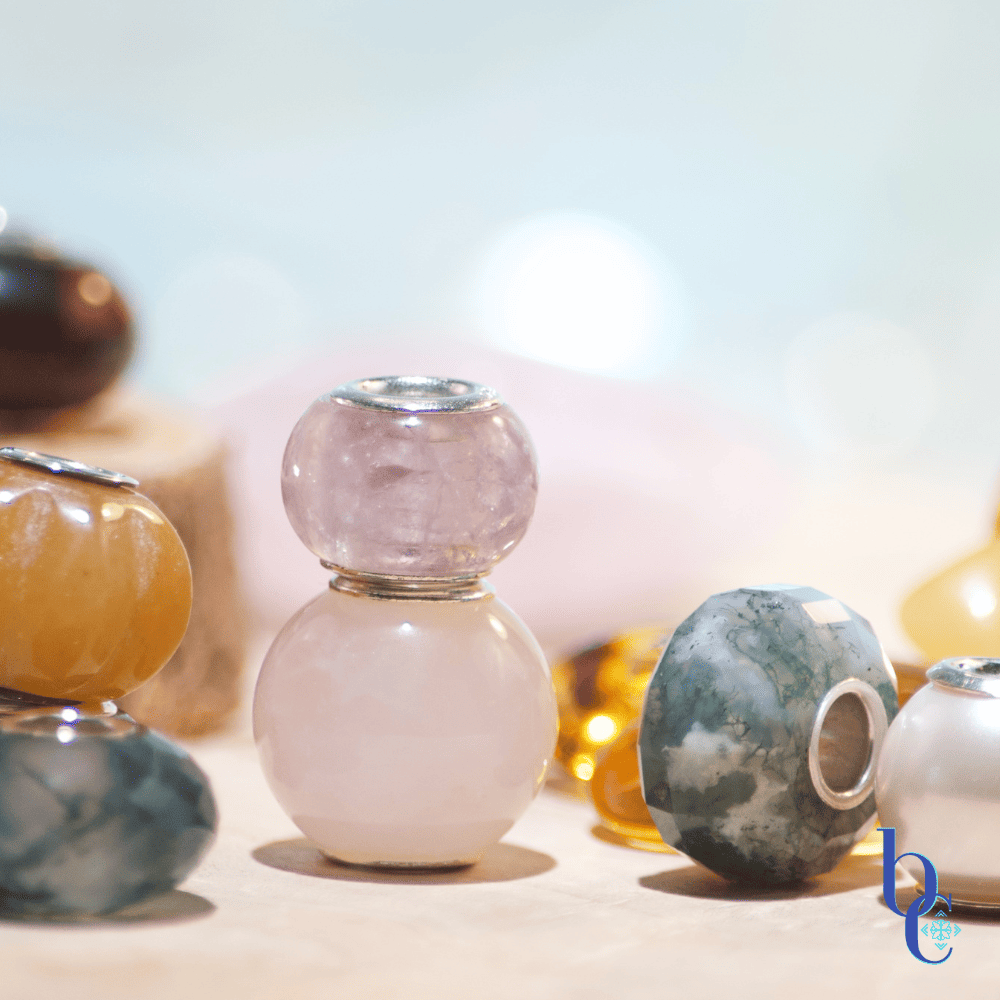 An Image of natural stone European bracelet beads with sterling silver cores. The lighting makes them sparkle and shine and shows their translucence and delicate nature.