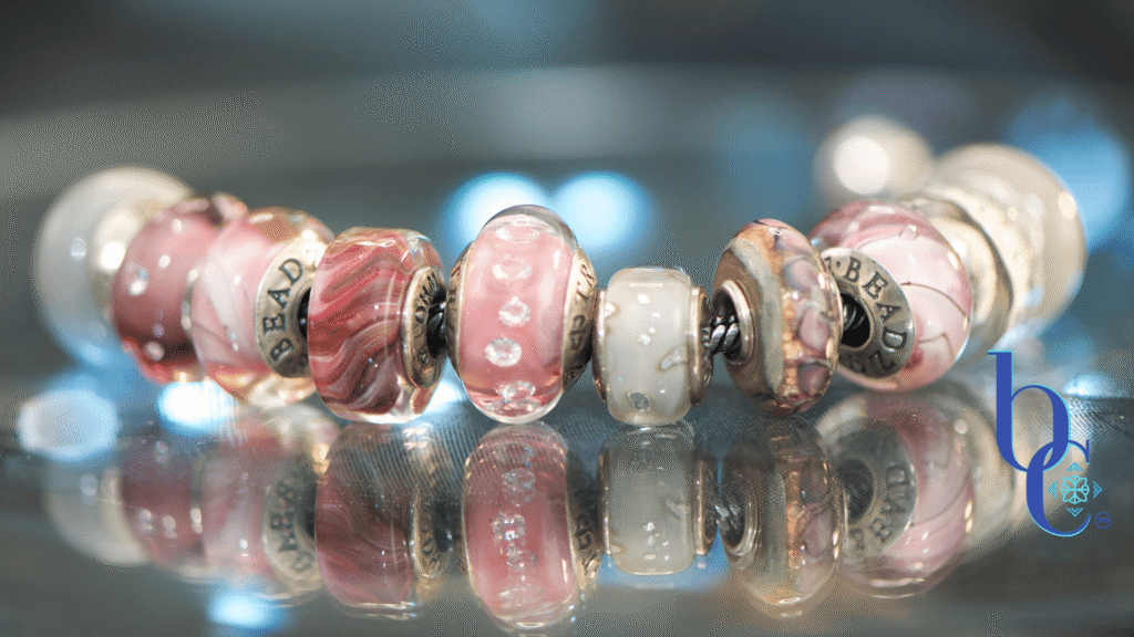 A luxury full-chain European charm bracelet layout featuring matte gray concrete beads, translucent smoky purple glass, and a sparkling pink lilac crystal charm centered on a sterling silver chain. Description: A high-contrast studio macro photograph capturing the rich textural transitions from industrial matte surfaces to shimmering glass facets, emphasizing the butterfly wing motif of the central charm.