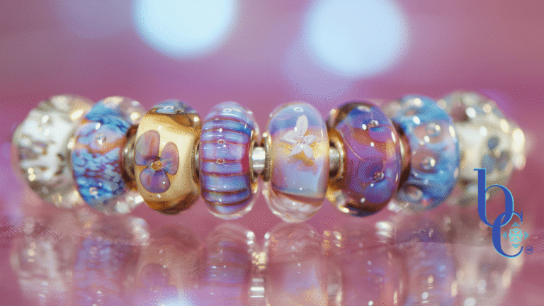 Close-up macro photograph of a glowing violet and blue European charm bracelet, featuring Trollbeads Sea Anemone and Purple Heaven glass beads on a sterling silver chain, resting on an iridescent purple surface with bokeh lighting.